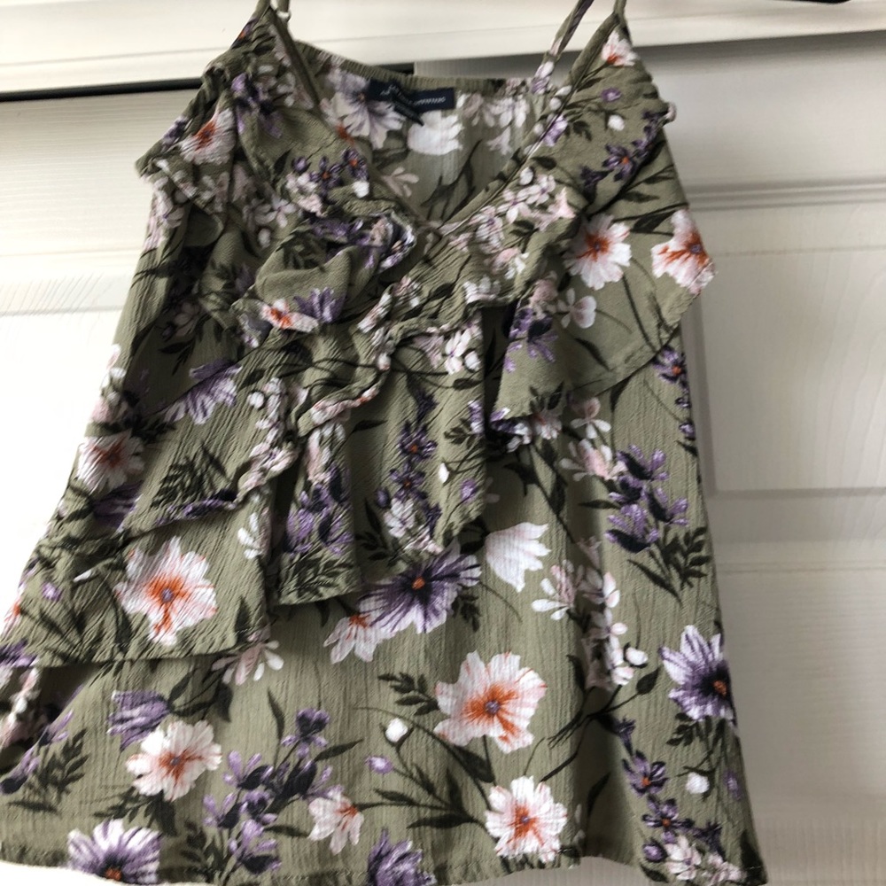 a green flowery spaghetti strap shirt
